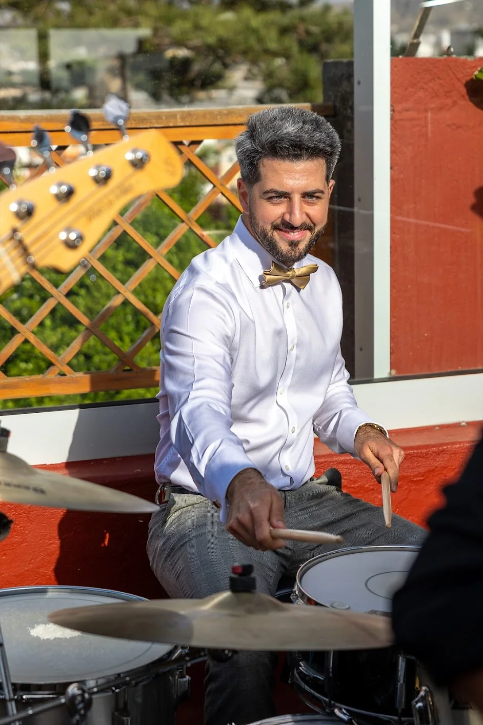 Oscar Lopez holding drumsticks at his sister’s wedding in Gran Canaria