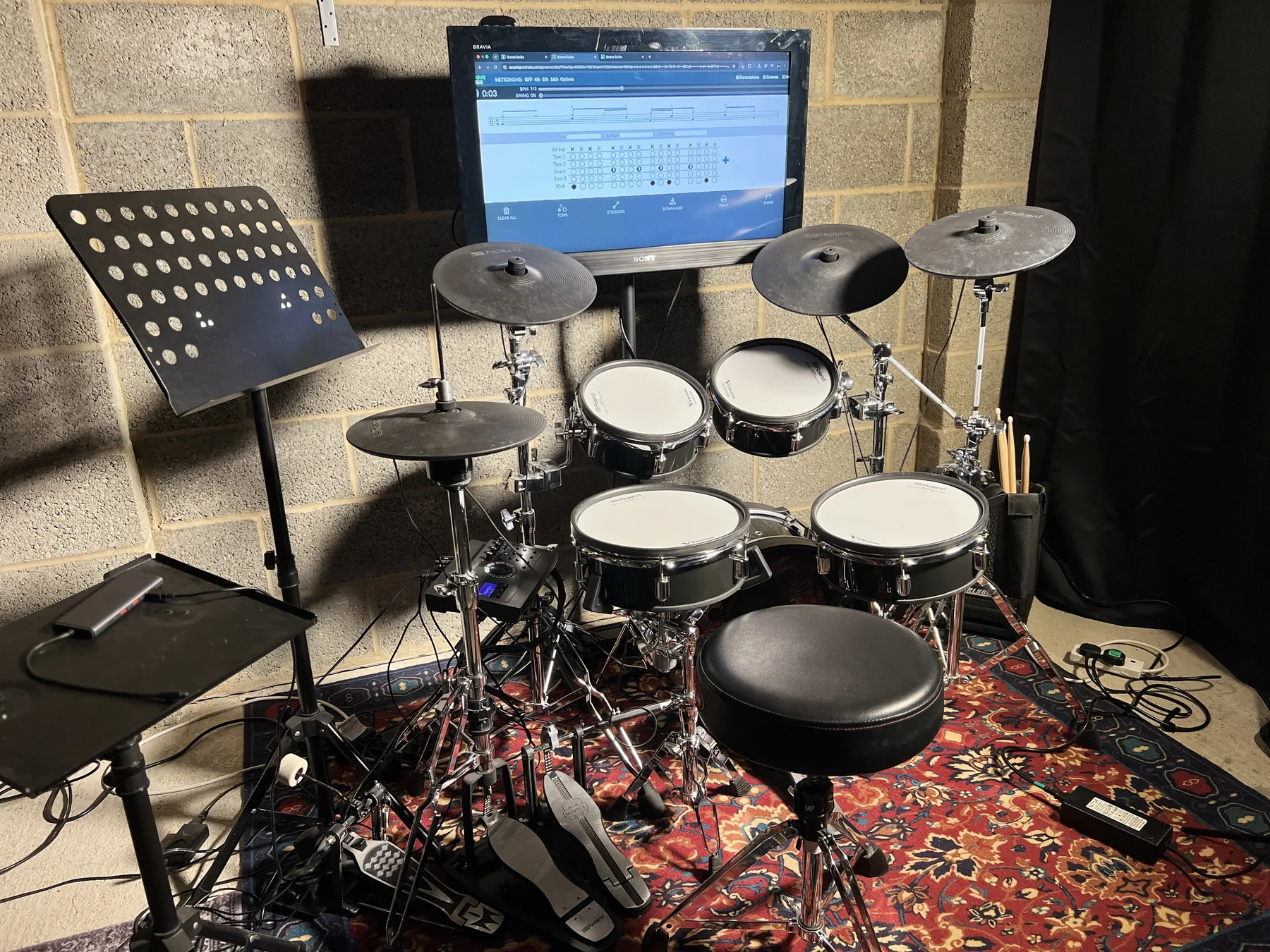 Electronic drum kit and drum notation screen in Oscar’s studio