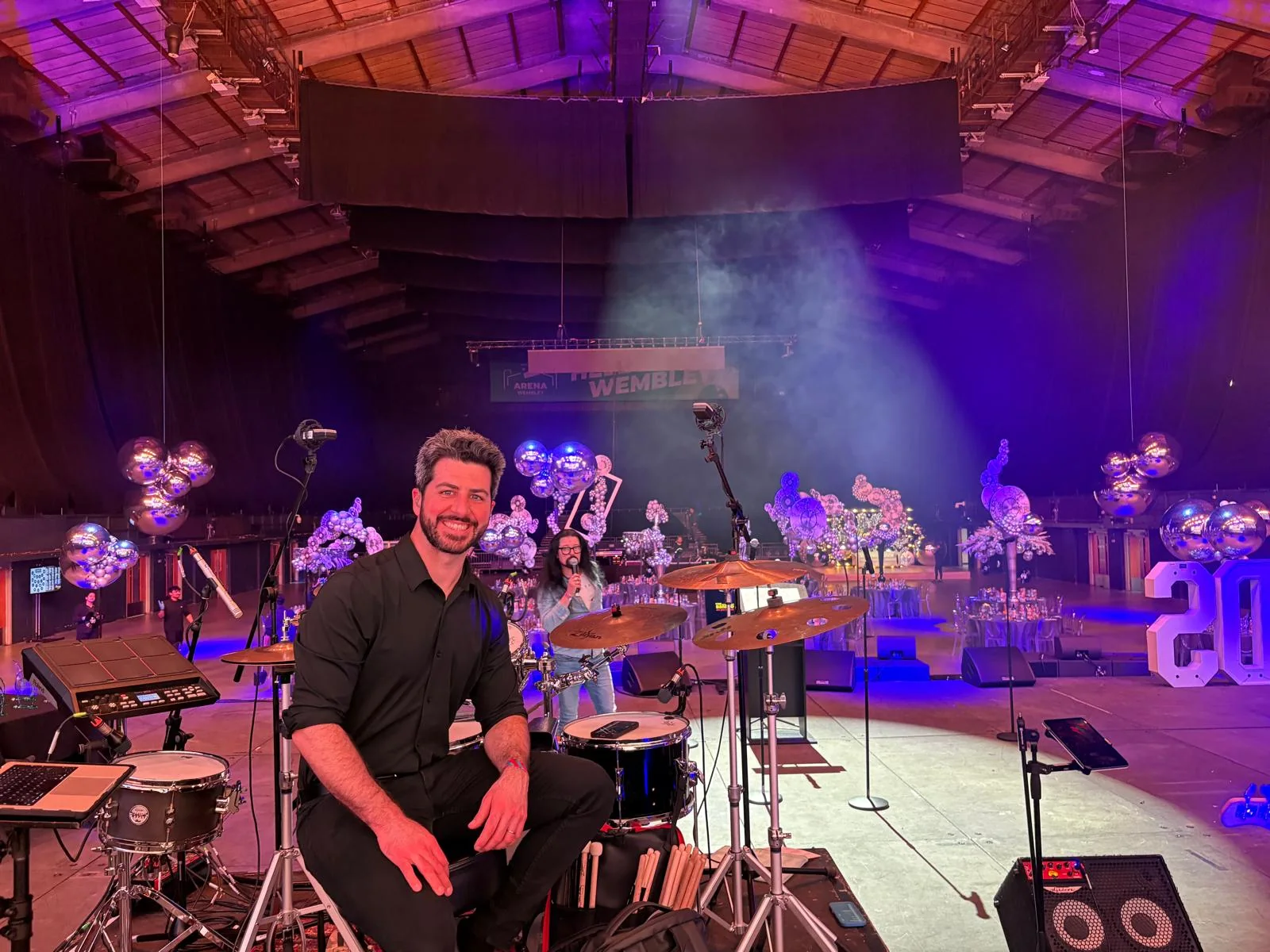 Oscar Lopez at his drum kit with Willy from Neonfly at Wembley